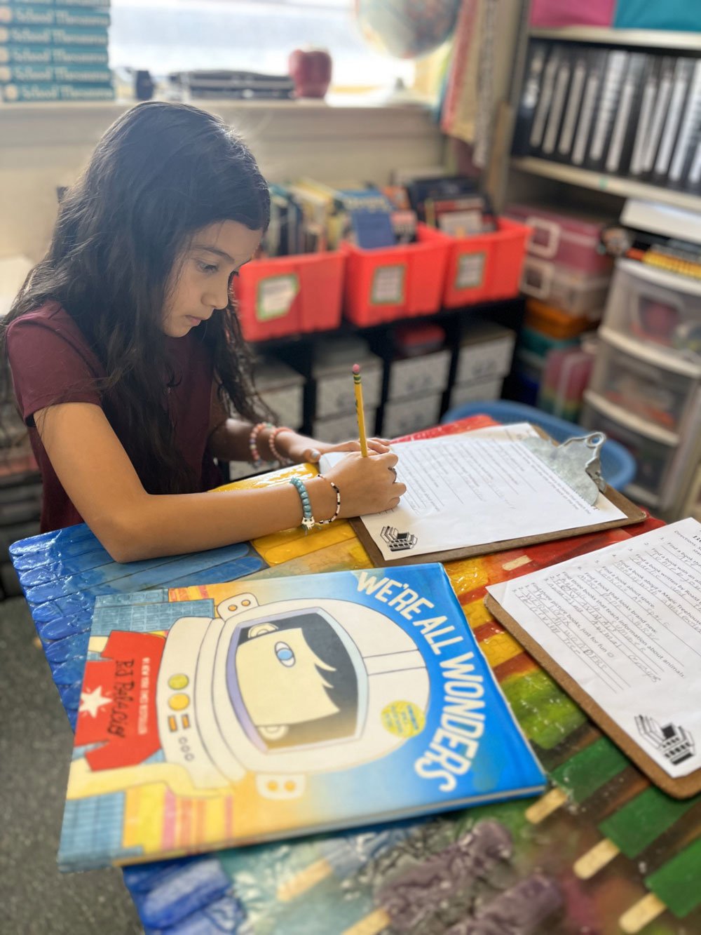girl writing on clipboard